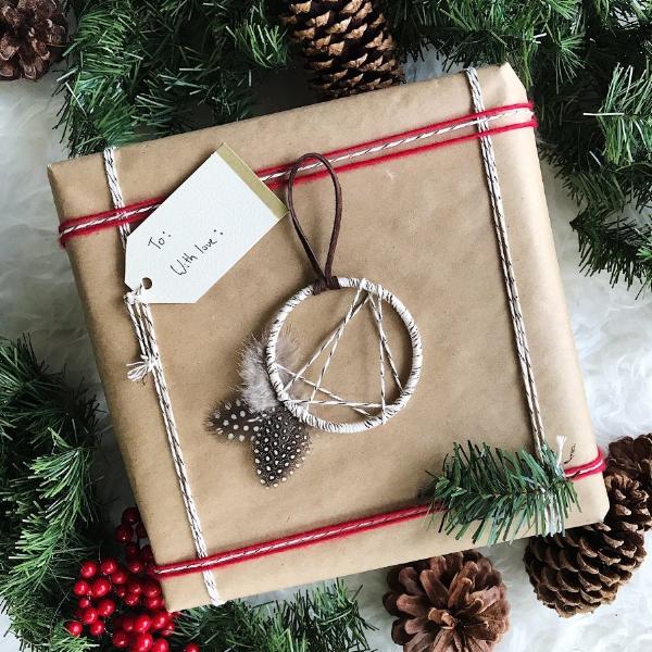 Boho Dreamcatcher Christmas Ornament shown as a holiday package accessory